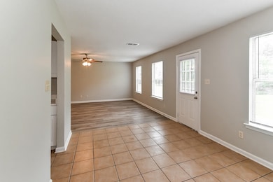 Foyer entrance featuring light tile patterned floors and ceiling fan