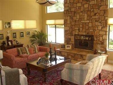Living room with fireplace and catheral ceilings.