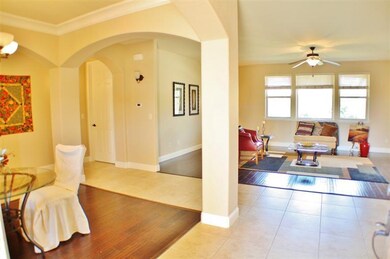 The foyer with an open living/dining/and kitchen s