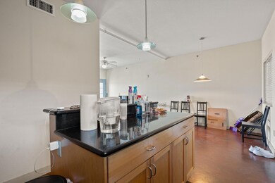 Kitchen featuring dark countertops, concrete floo