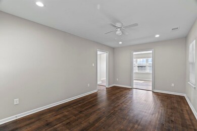 Spare room with ceiling fan, dark wood-style floors, and recessed lighting