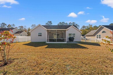 Back of house with a sunroom and a yard