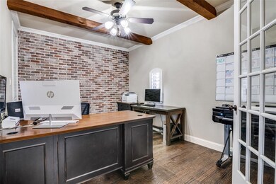 Beautiful study to the right upon entry. French doors, brick accent wall, beamed ceiling and a closet.