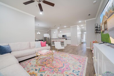 Living area with crown molding, wood finished floors, a ceiling fan, and recessed lighting