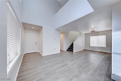 Unfurnished living room featuring stairway, light