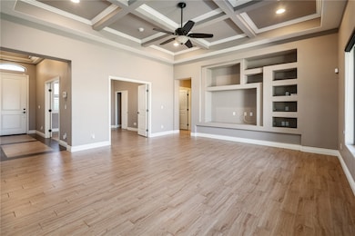 Unfurnished living room featuring a ceiling fan, o