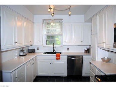 WHITE KITCHEN W/ CORIAN COUNTERTOPS