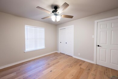 Unfurnished bedroom with a closet, light hardwood 