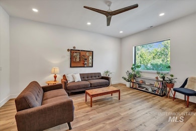 Living area featuring ceiling fan, light wood-style floors, and recessed lighting