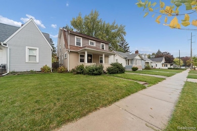 View of front of property featuring covered porch and a front yard