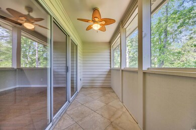 Unfurnished sunroom with a ceiling fan