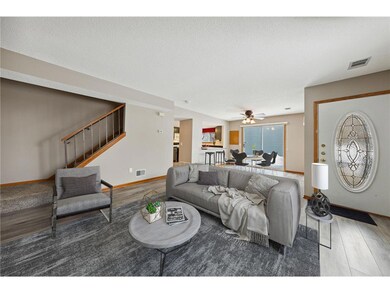 Living room with fireplace, leading into Dining ar