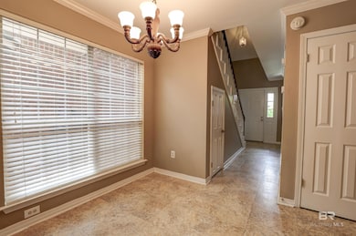 Unfurnished dining area with a notable chandelier, light tile floors, and crown molding