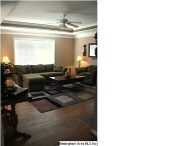 Spacious living room with hardwood floors & faux w