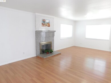 Unfurnished living room with ornamental molding, light wood-type flooring, and a tiled fireplace