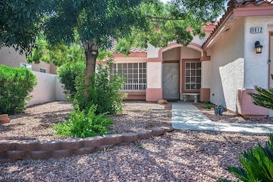 Property entrance with a tile roof and stucco siding