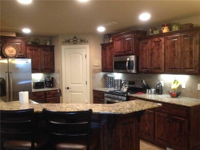 Kitchen. Kitchen has raised bar, stainless applian