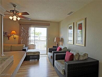 Living room with light wood-style flooring, a text