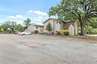 View of front of house featuring fence, central AC