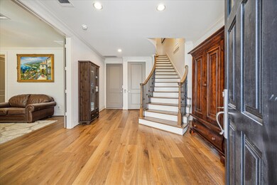 Large entry with curved staircase and elevator ins