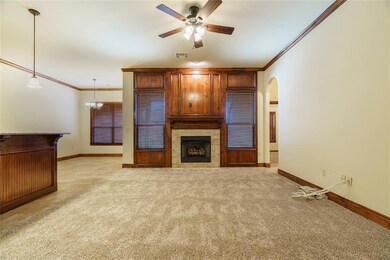 Unfurnished living room featuring ornamental moldi