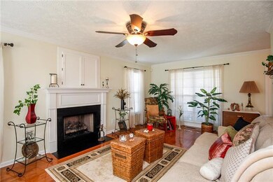 The living room has a gas fireplace and a convenient nook above to stow your TV away.