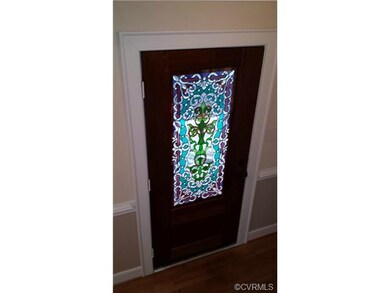 This custom stained glass front door is another touch that ads a special feel to the house and lets the sun shine into the foyer.  Not hard wood and chair rail.