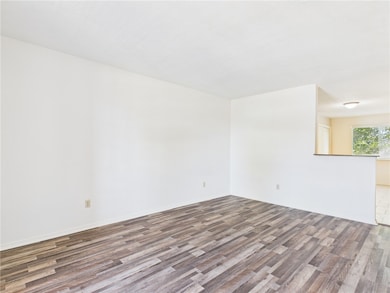 Spare room featuring wood finished floors