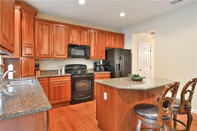 The fully-equipped kitchen boasts cherry cabinetry