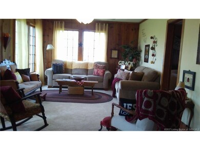 Oversized living room features large windows, soli
