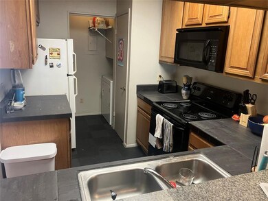 Kitchen featuring black appliances, a sink, washe