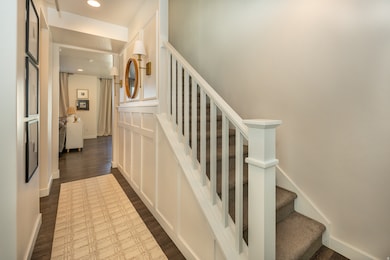 Stairs featuring wood finished floors and recessed lighting
