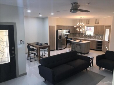 Living room featuring a chandelier, ceiling fan, and light tile patterned floors