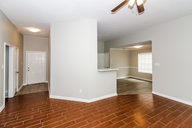 Unfurnished room with dark wood-type flooring and a ceiling fan