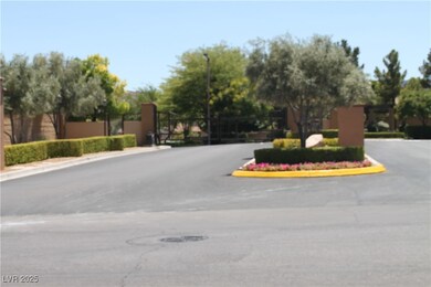 View of road with a gated entry, curbs, street lig