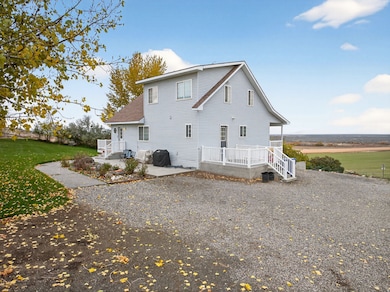 Rear view of house with a yard and roof with shingles