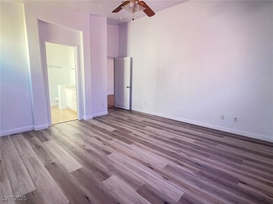 Unfurnished bedroom with ceiling fan, ensuite bath
