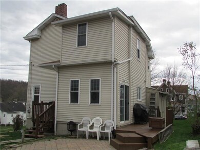 REAR OF HOME WITH SIDE DECK, SLIDING DOORS FROM MU