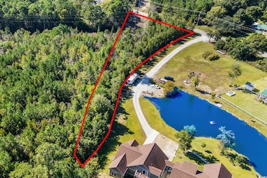 Aerial overview of property's location with a large body of water and property boundaries highlighted