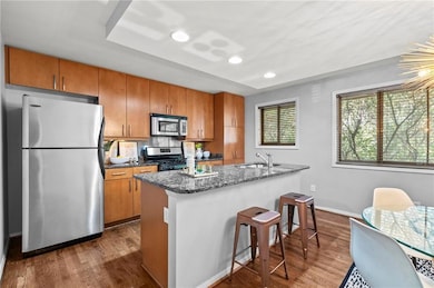 Kitchen with stone counter tops, stainless appliances, and full island
