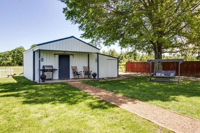 Behind the home you will find an 18x30 workshop with covered porch!