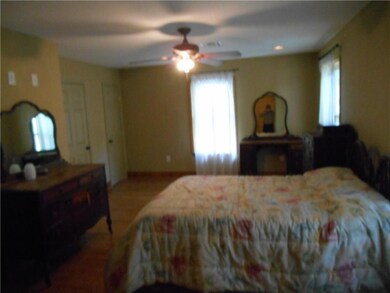 LARGE MASTER BEDROOM HAS BAMBOO FLOORS AND TWO BAT