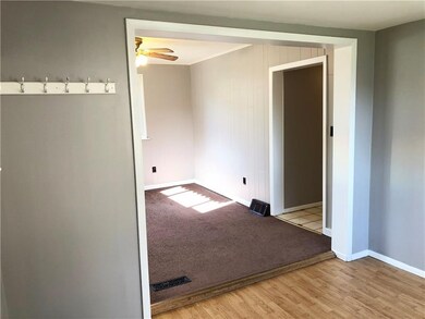 Living Room is carpeted, has two large windows and