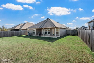 Back of house featuring a patio, a shingled roof, and a fenced backyard