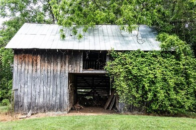 Property features a total of four barns and outbuildings.