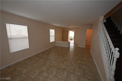 Tiled spare room with stairs and baseboards