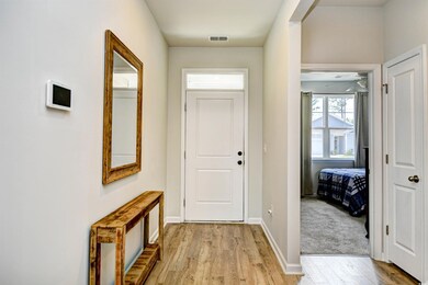 Foyer with light wood-style floors, baseboards, and a ceiling fan