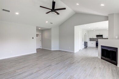 Unfurnished living room featuring a ceiling fan, 