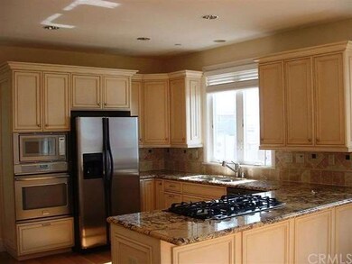 open kitchen area with modern appliances. Fridge i