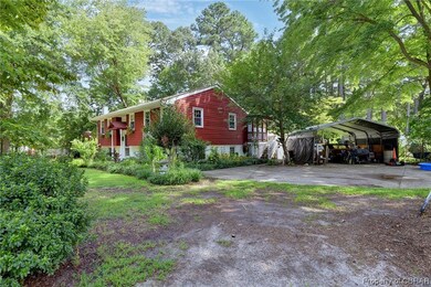 Side view of the home has paved driveway.  The cov